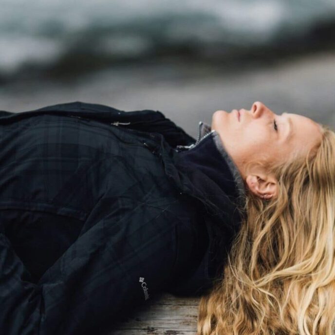 woman lying on log